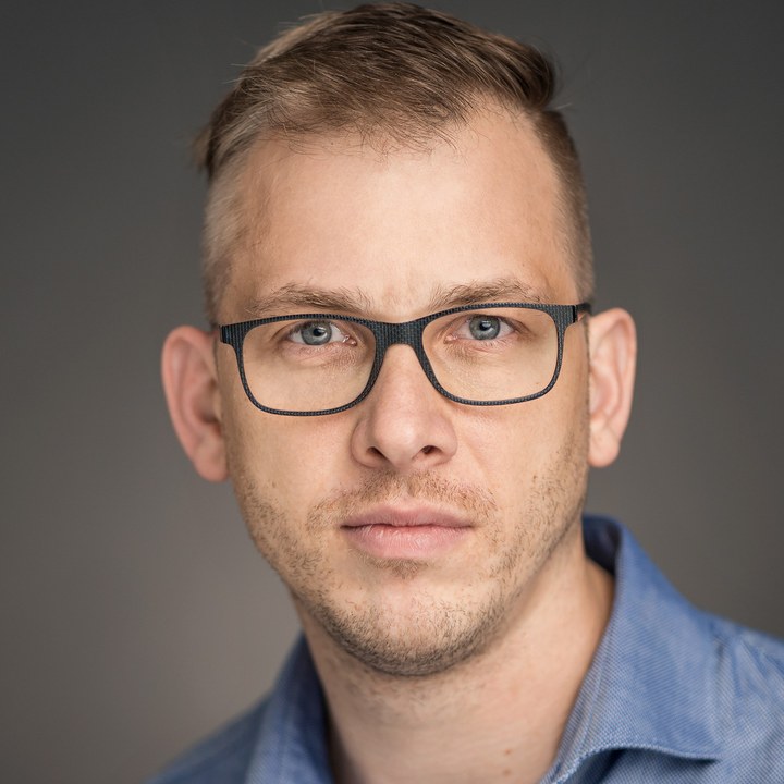 Steven Biel, Portrait von vorn: kurzes Haar, Brille, dunkles Hemd